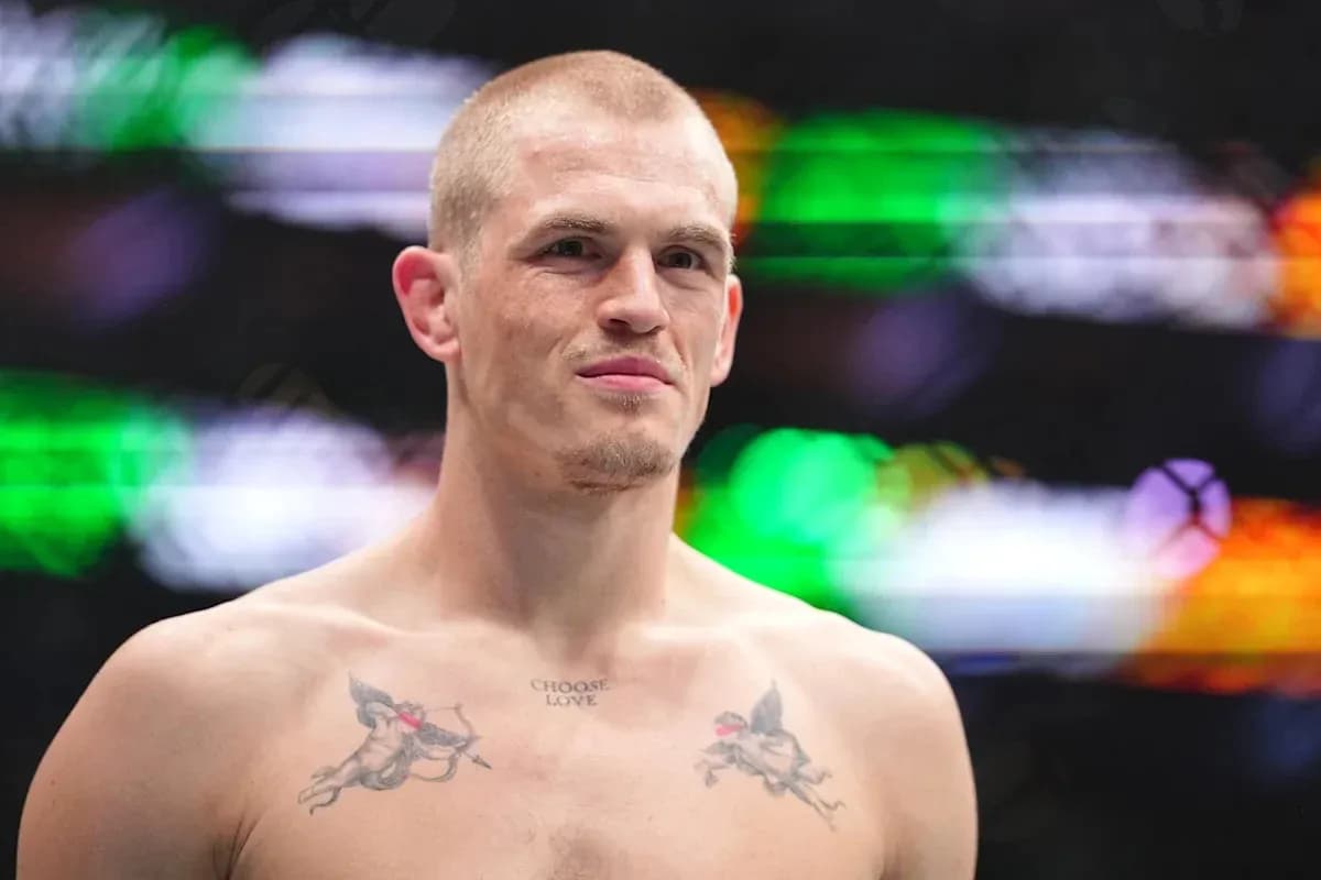 Bare-chested fighter with tattoos at event