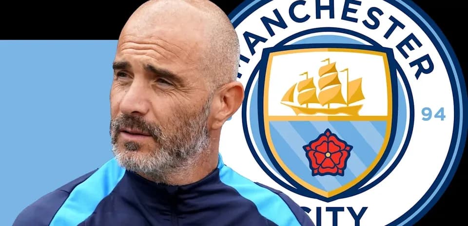 Coach next to Manchester City club logo