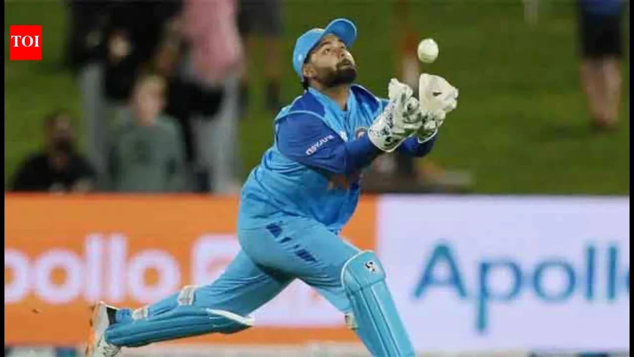 Wicketkeeper attempting to catch a cricket ball Wicketkeeper attempting to catch a cricket ball
