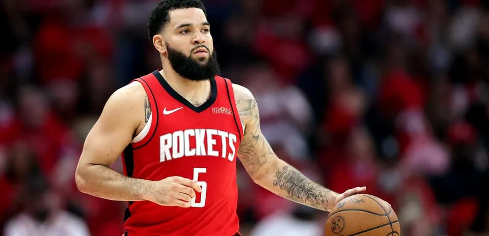 Player dribbling basketball wearing Rockets jersey