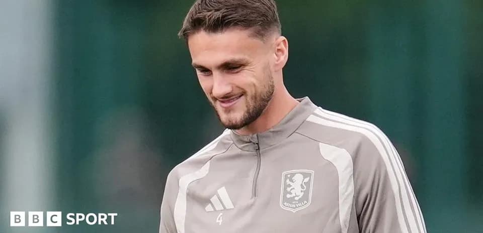 Player in Aston Villa training kit smiling during practice