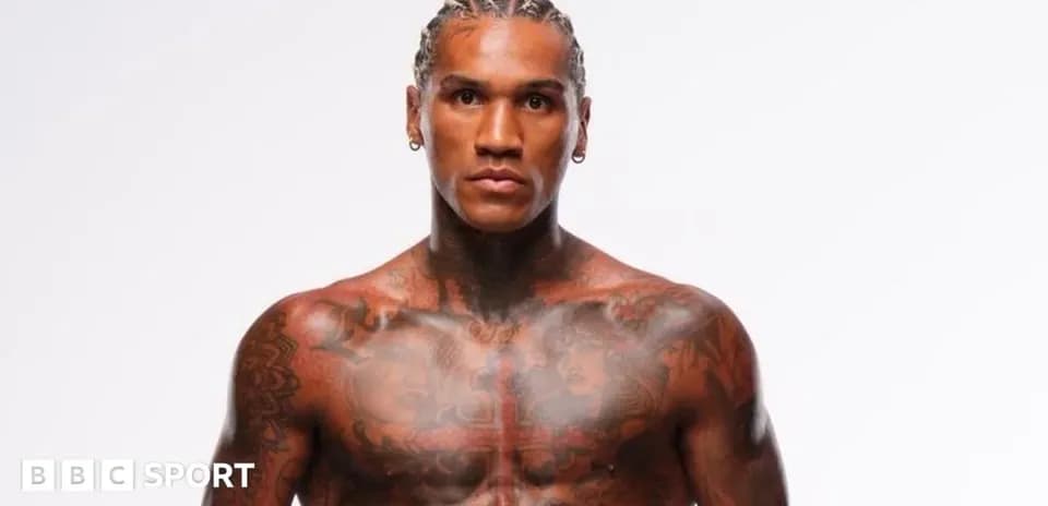 Tattooed athlete posing in a studio setting