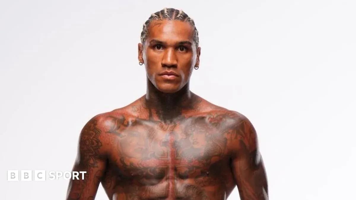 Tattooed athlete posing in a studio setting