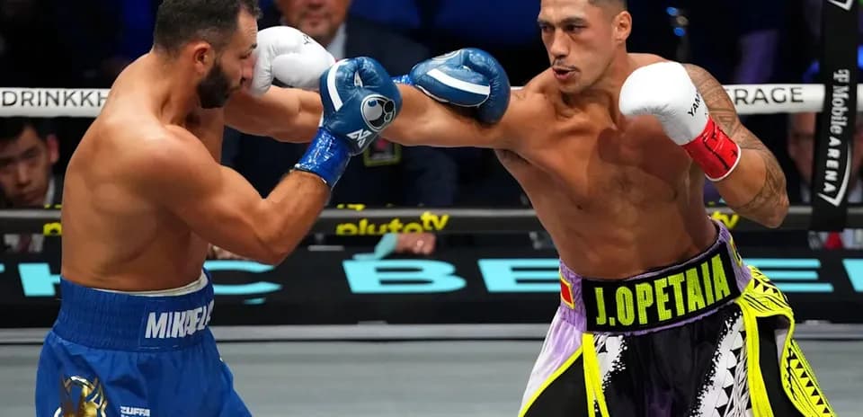 Two boxers exchanging punches in the ring