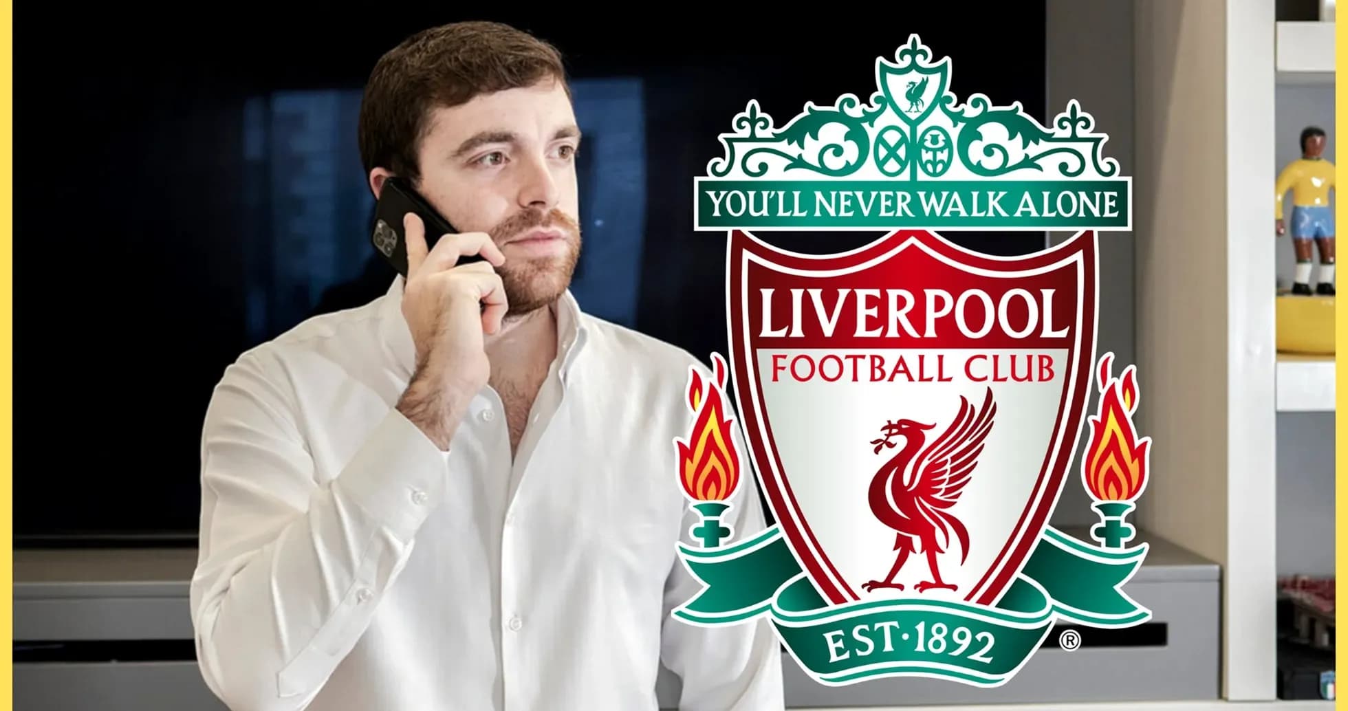 Man talking on phone with Liverpool FC logo