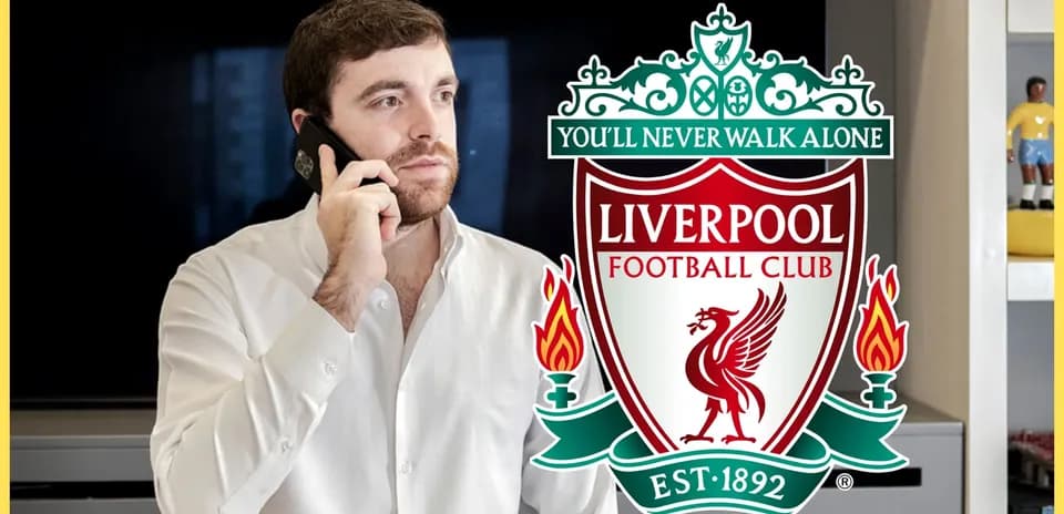 Man talking on phone with Liverpool FC logo