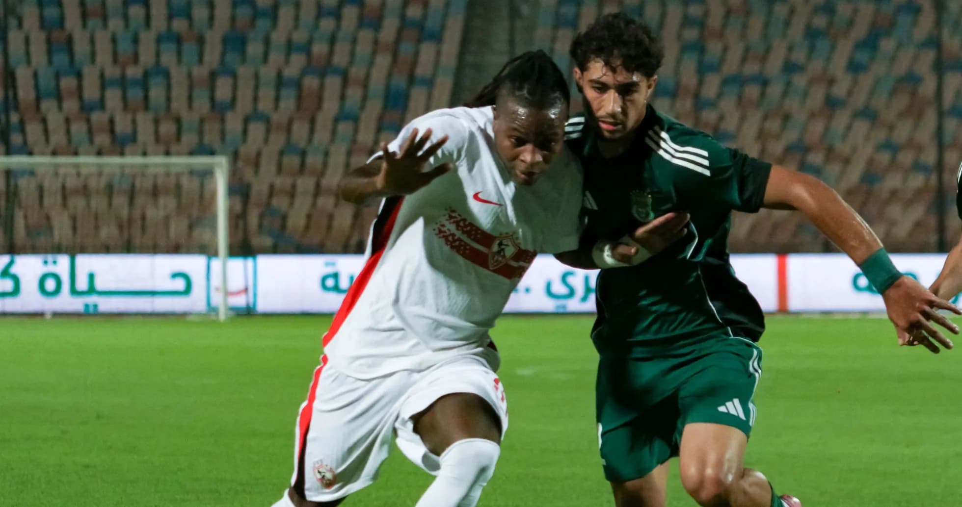 Two players contesting for the ball during match