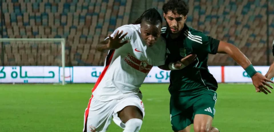 Two players contesting for the ball during match