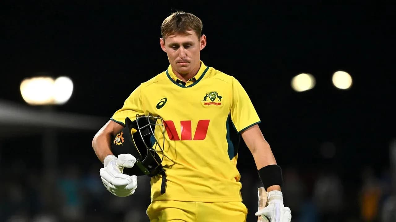 Australian cricketer walking off the field after dismissal