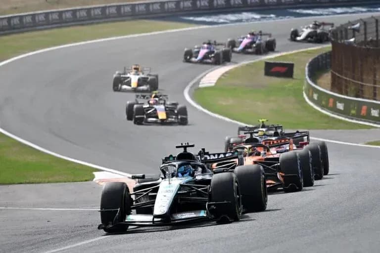 Formula 1 cars racing on a winding circuit