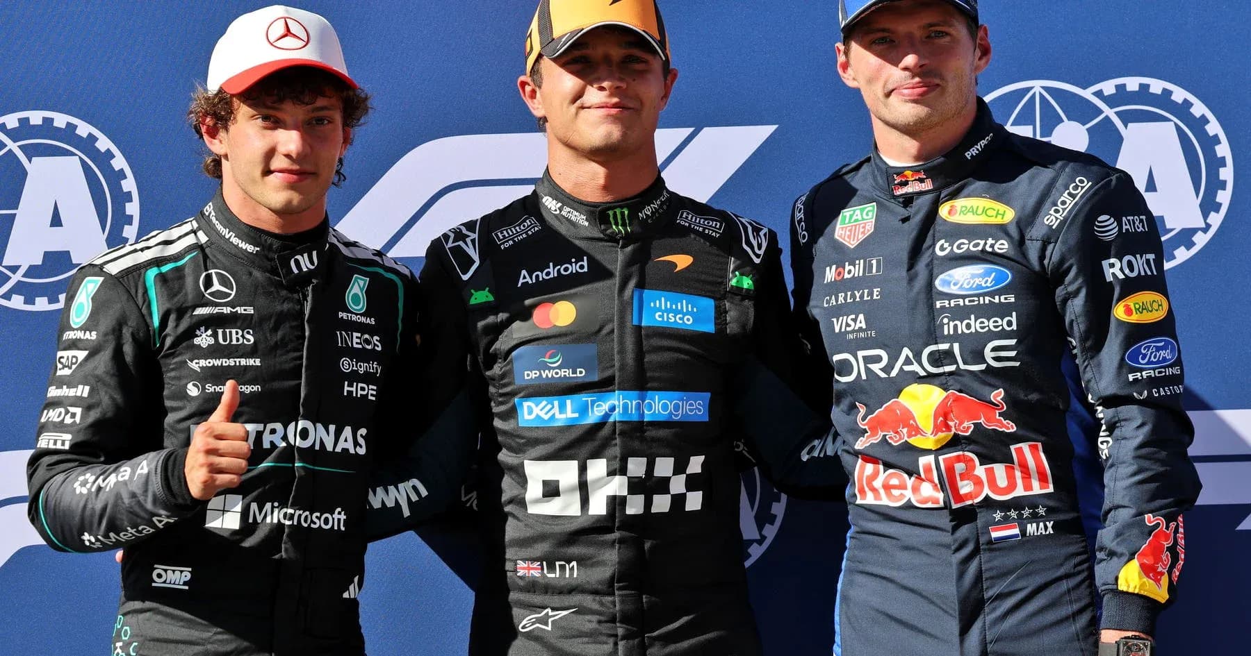 Three Formula 1 drivers posing after the race