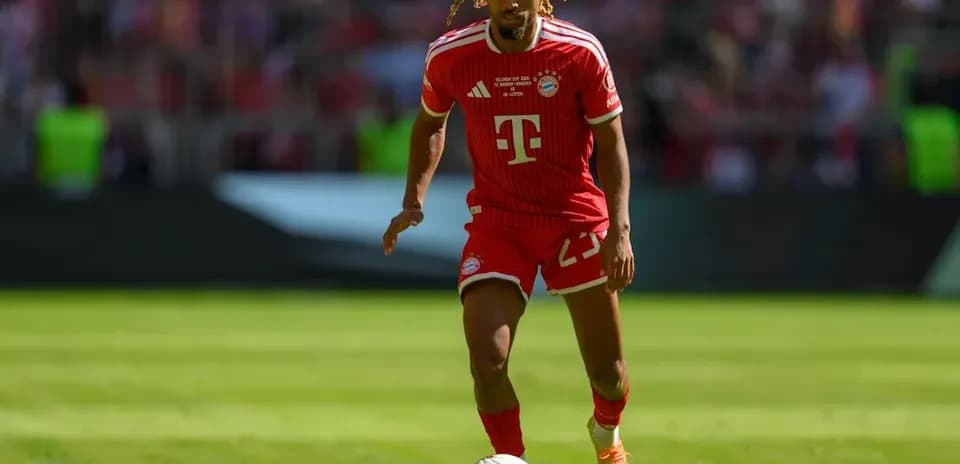 Player in red Bayern Munich kit dribbling ball
