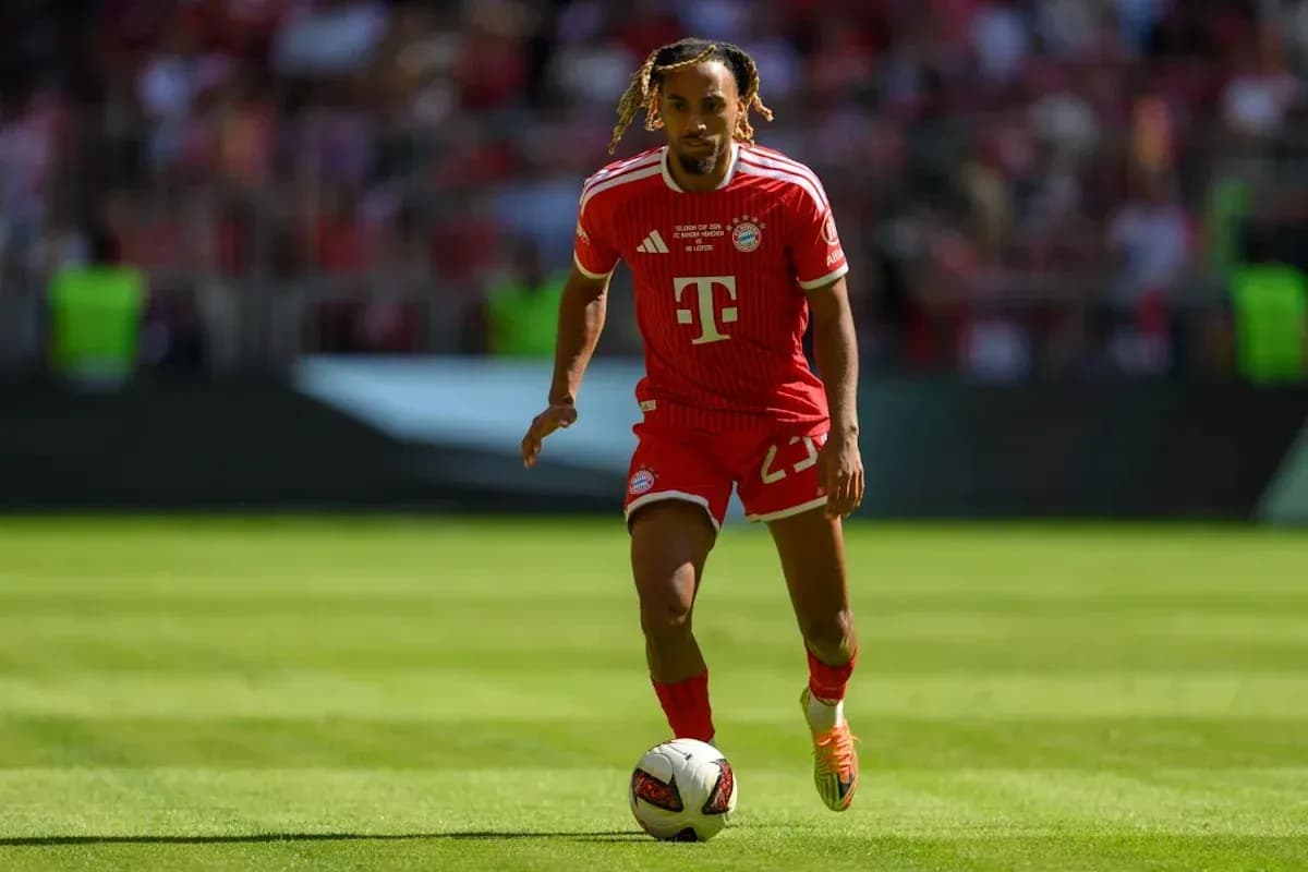Player in red Bayern Munich kit dribbling ball