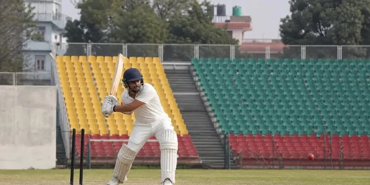 Batsman preparing to strike ball in cricket match