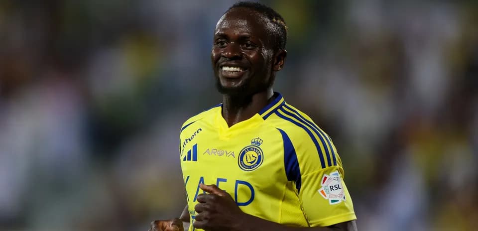 Player celebrating in Al Nassr yellow jersey