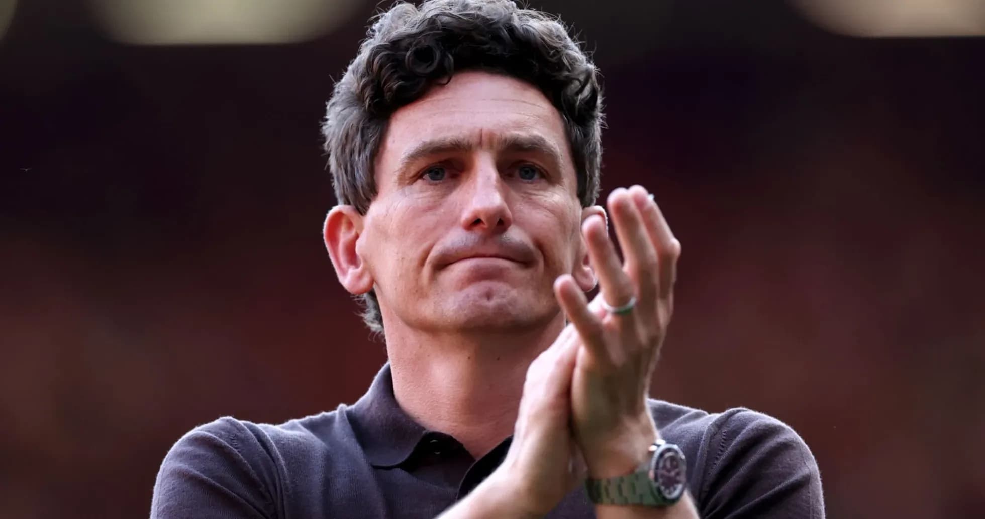 Man applauding in a sports venue
