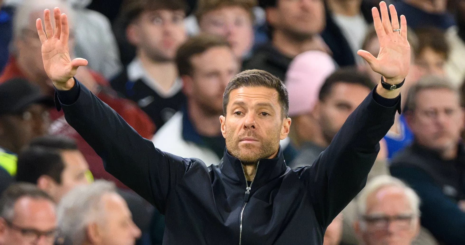 Coach gesturing during a football match in crowd