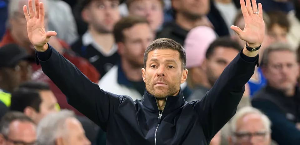 Coach gesturing during a football match in crowd