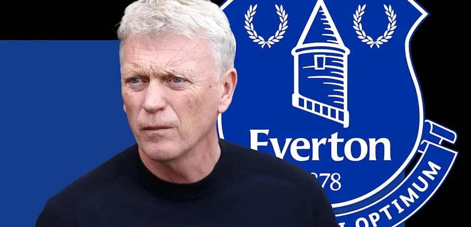 Manager in front of Everton FC logo backdrop