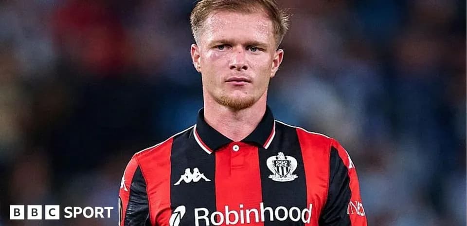 Player in black and red jersey on the field