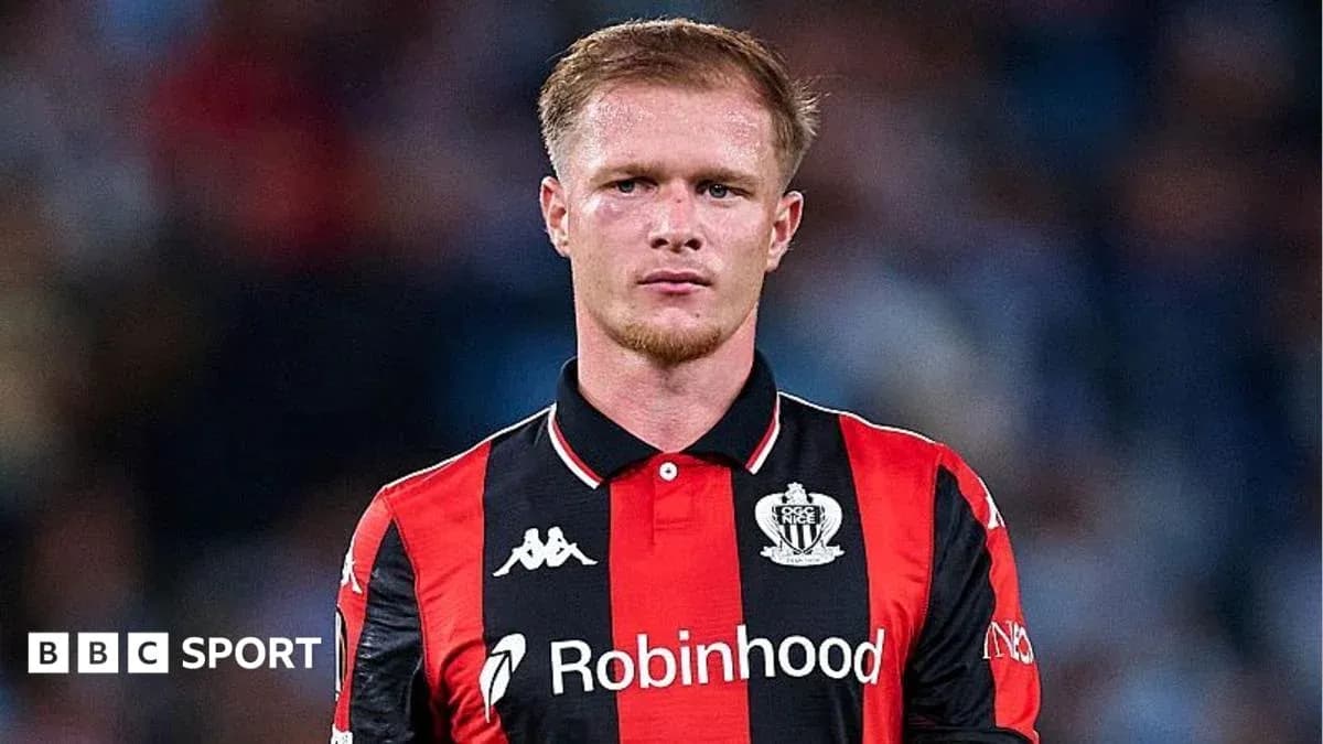 Player in black and red jersey on the field