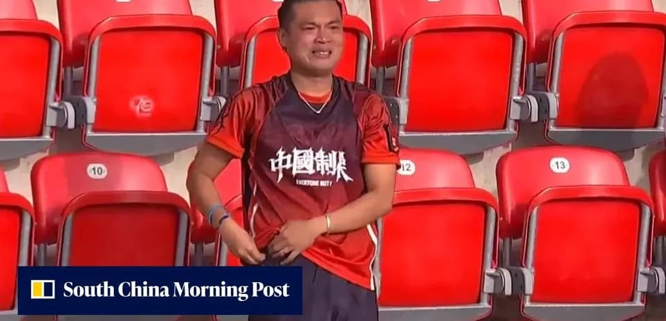Fan wearing red jersey in empty stadium seats