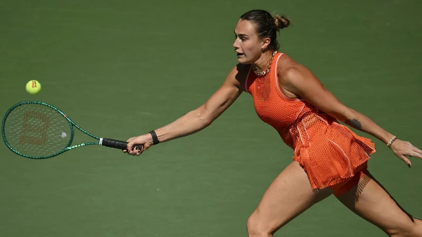 Player reaching for a tennis ball during match