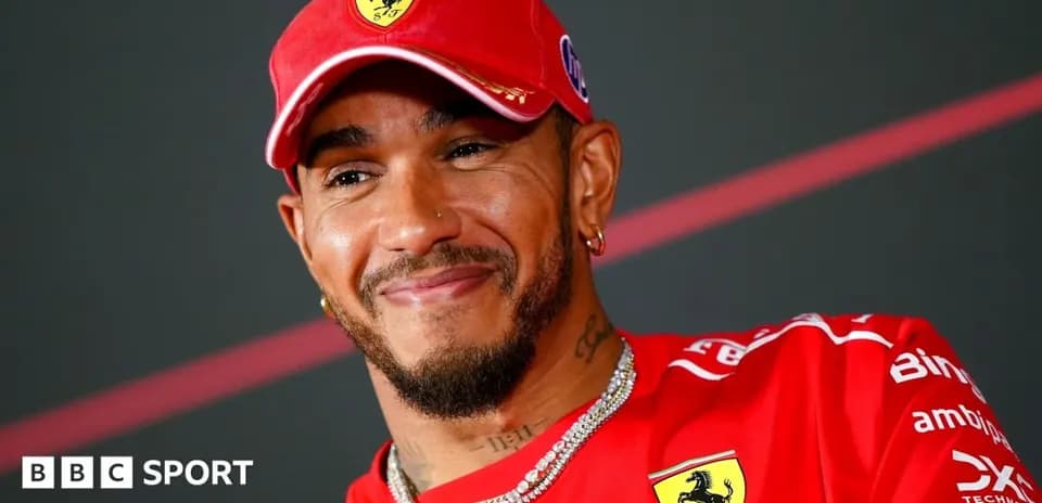 Driver in Ferrari attire during press conference