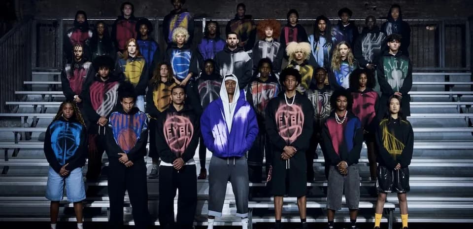 Group of people in hoodies posing on bleachers