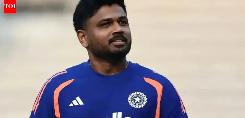 Cricketer wearing blue team jersey on field