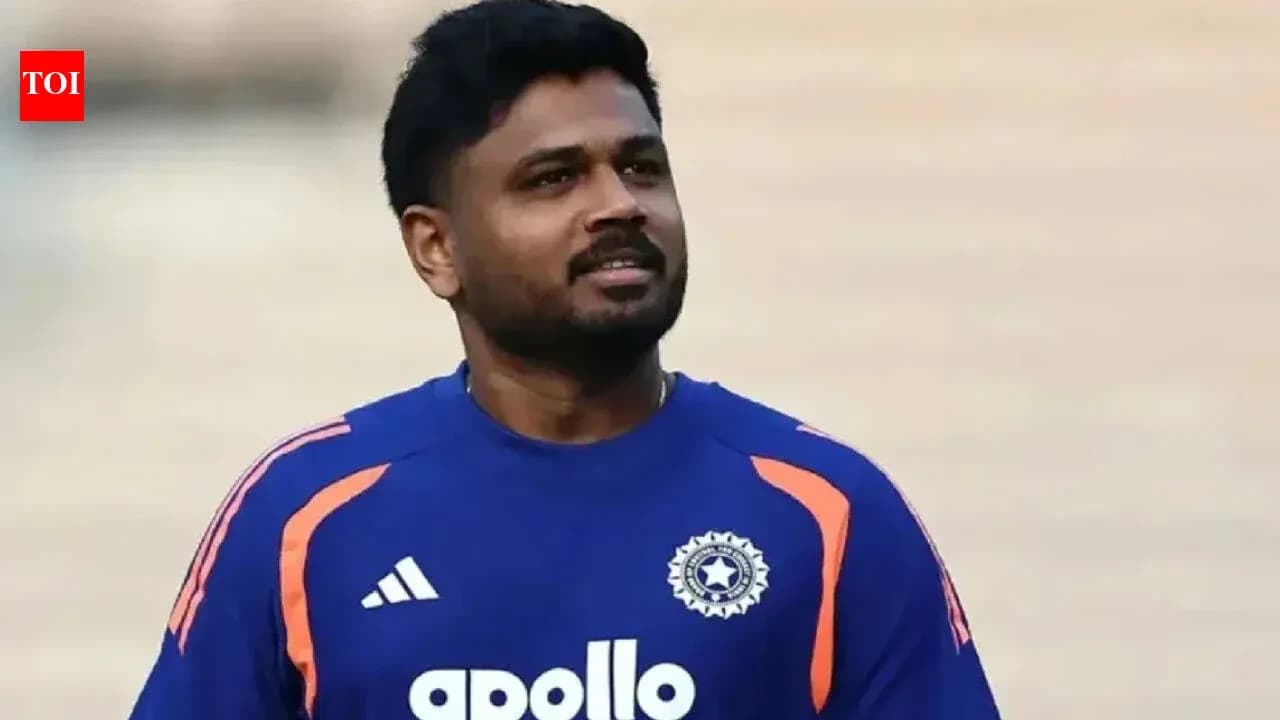 Cricketer wearing blue team jersey on field