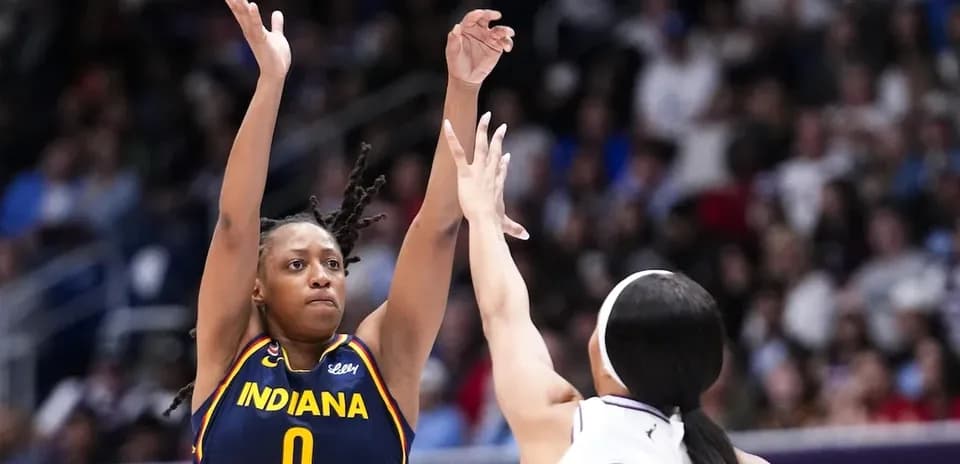 Indiana player shooting over defender during game
