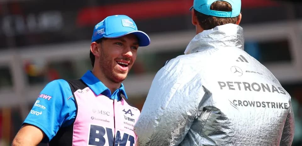 Two Formula 1 drivers chatting in team gear