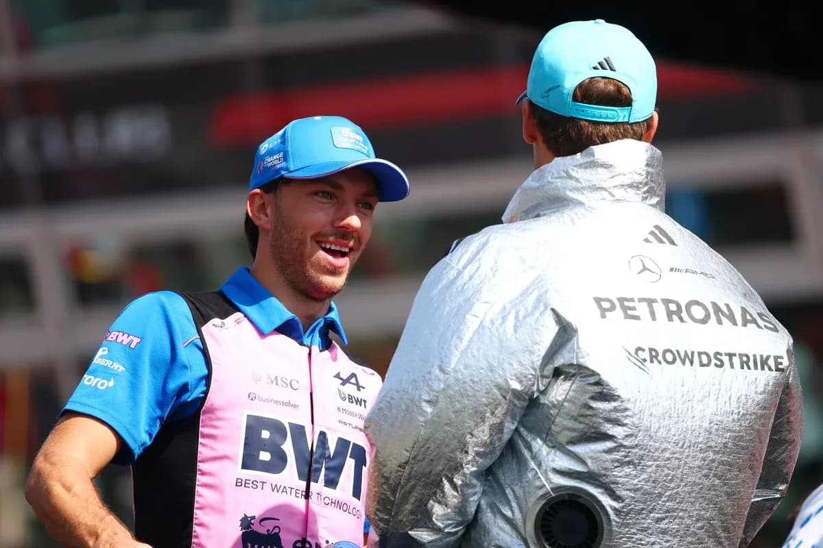 Two Formula 1 drivers chatting in team gear