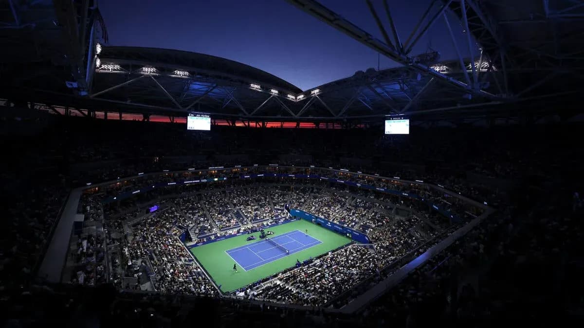 Night view of packed stadium during tennis match