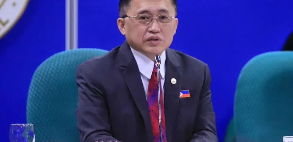 Official speaking at a conference table with microphone