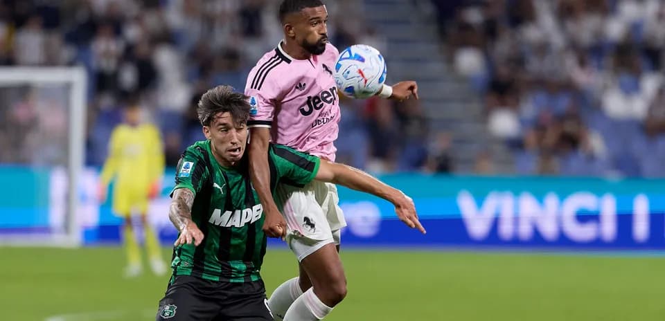 Two players contesting for the ball during match
