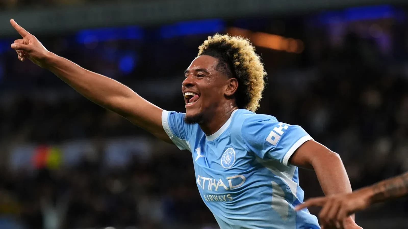Player celebrating goal with raised hand during match