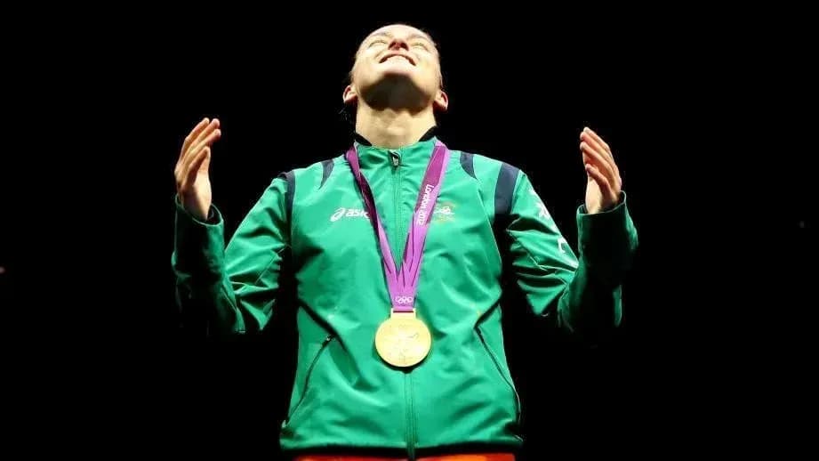 Athlete celebrating with gold medal in spotlight