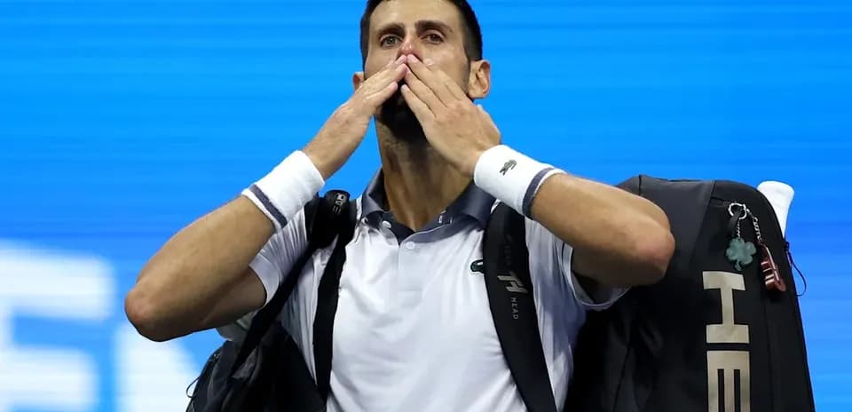 Tennis player blowing kisses to crowd after match