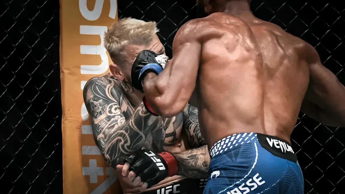 Two fighters engaged in close combat in the octagon