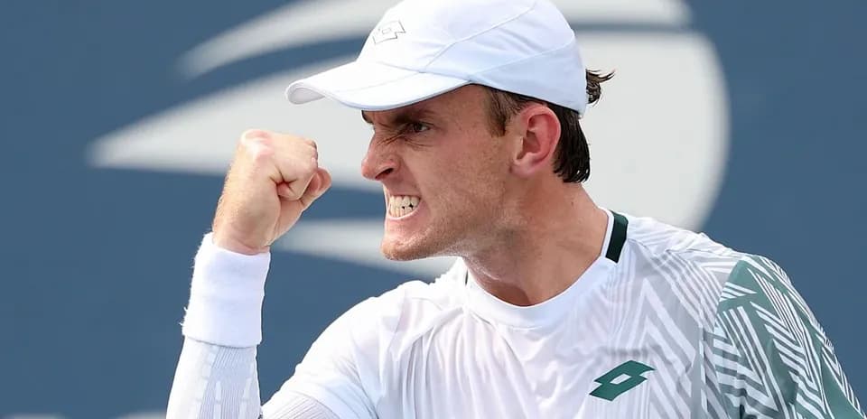 Tennis player celebrating a point with clenched fist