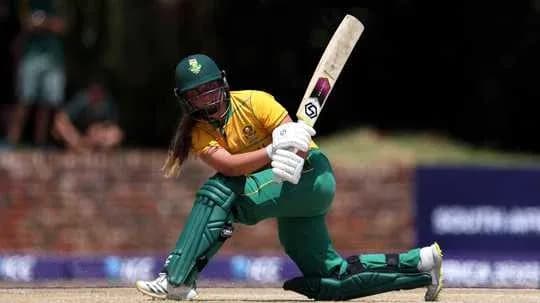 Batter playing a shot in women's cricket match