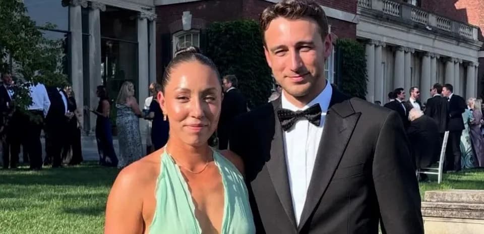Couple posing in formal attire at outdoor event