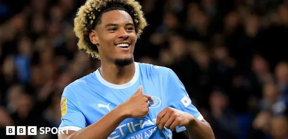 Player celebrating a goal in Manchester City kit