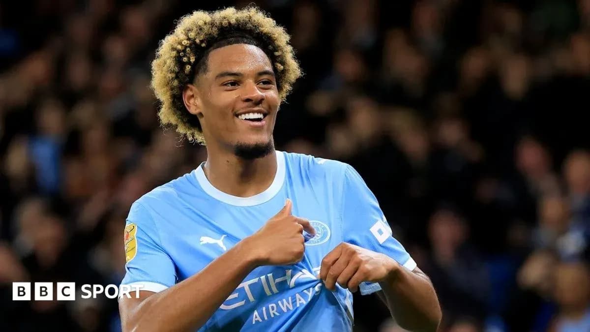 Player celebrating a goal in Manchester City kit