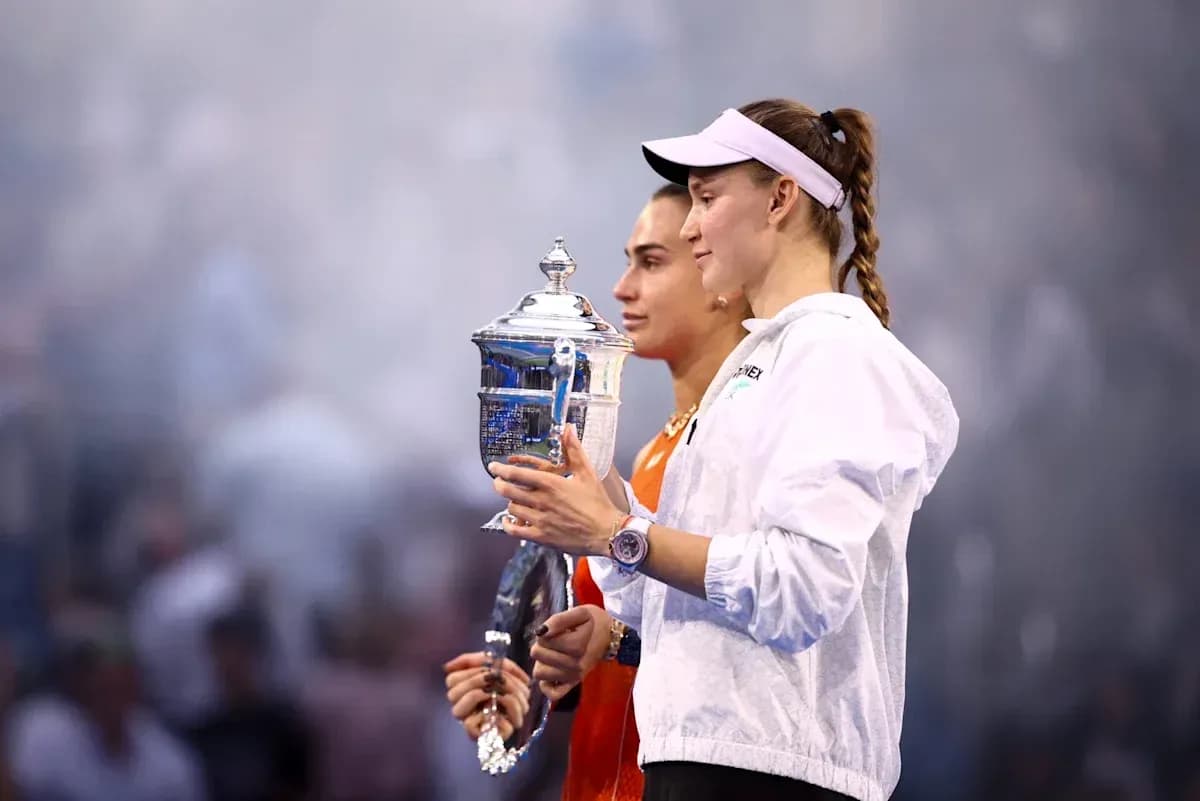 Two tennis players holding trophies after match