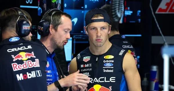 Team members discussing strategy in the garage