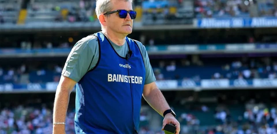 Coach in training gear walking on the pitch