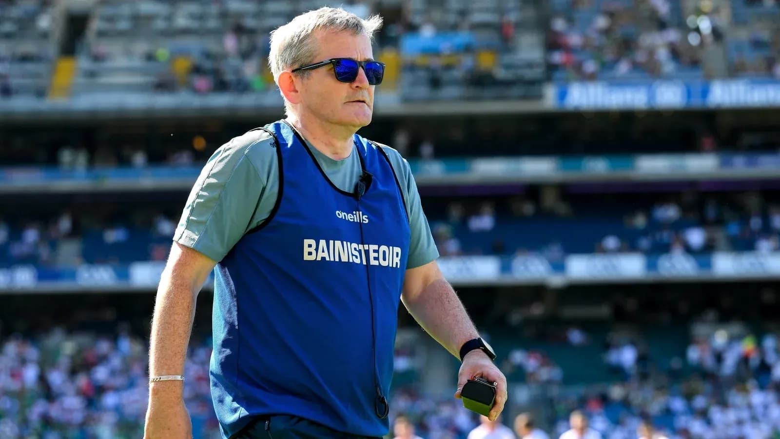 Coach in training gear walking on the pitch